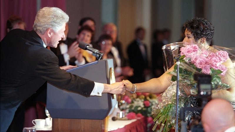 President Bill Clinton greets singer Aretha Franklin during her performance at the annual White House Correspondents dinner